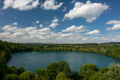 Scenic view of lake in forest against sky