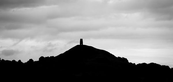 Low angle view of silhouette built structure against sky