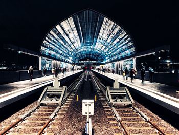 People at railroad station platform in city