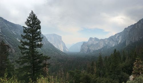 Scenic view of mountains against cloudy sky