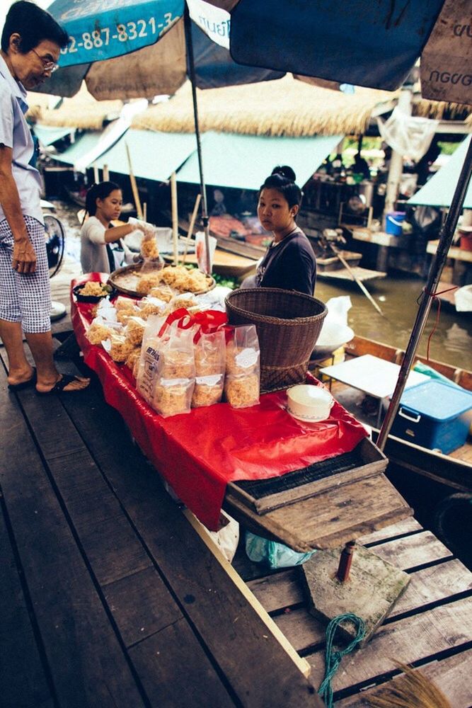 PEOPLE AT MARKET STALL