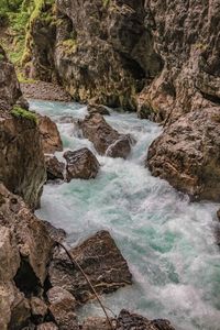 Scenic view of stream flowing through rocks