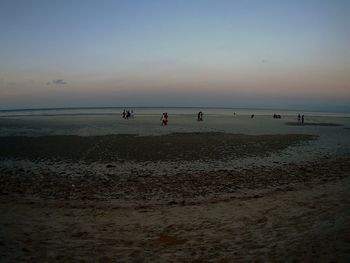 People on beach at sunset