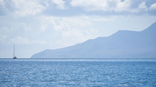 Sailboat sailing on sea against sky