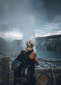 Rear view of woman looking at mountain range