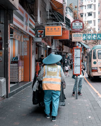 Rear view of people on street in city