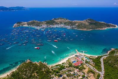 High angle view of sailboats on sea shore against sky