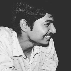 Close-up of smiling man in darkroom