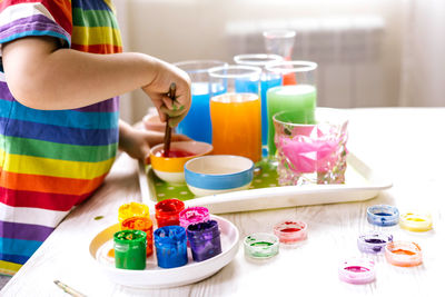 Midsection of boy mixing colours