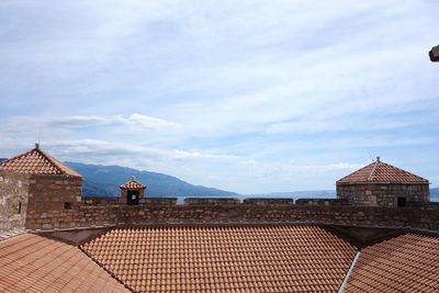 Roof of residential district against sky