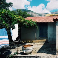 Laundry handing by house against mountain