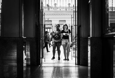 People walking in corridor of building