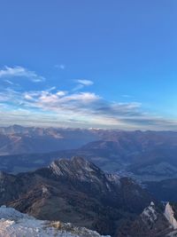 Scenic view of mountains against blue sky