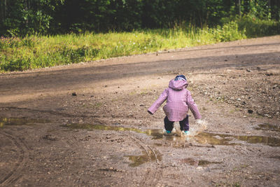 Full length of a girl walking on road