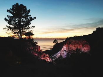 Scenic view of silhouette trees against sky during sunset