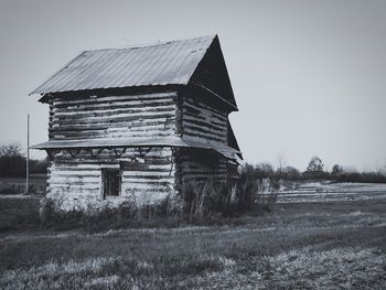 Abandoned built structure on field against clear sky