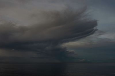 Scenic view of sea against storm clouds