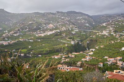 High angle view of townscape and mountains against sky