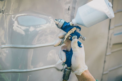 Close-up of hand holding white pipe