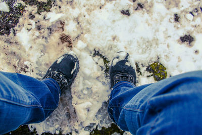Low section of man standing on land