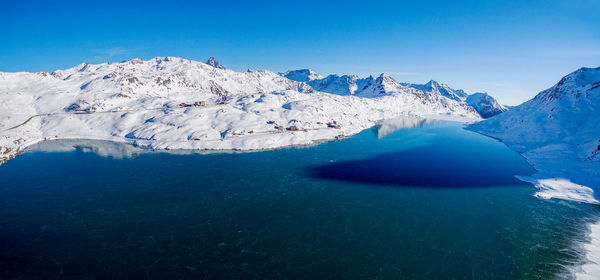 Scenic view of snowcapped mountains against clear blue sky