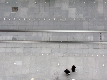 Directly above shot of people by tramway on street