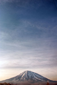 View of volcanic mountain against cloudy sky