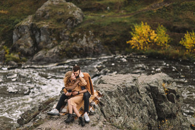 Happy people in love are travel hike in nature in the autumn forest. romantic trip to countryside