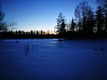 Scenic view of frozen lake against sky during winter