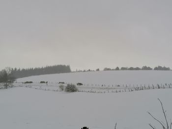 Scenic view of snow covered landscape against clear sky