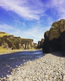 Rock formations by sea against sky