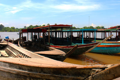 Boat moored on beach against sky