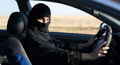 Portrait of woman sitting in car