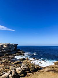 Scenic view of sea against blue sky