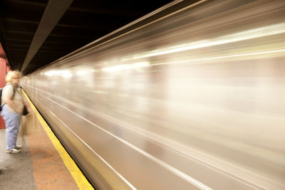 Speeding blurred train at railway station