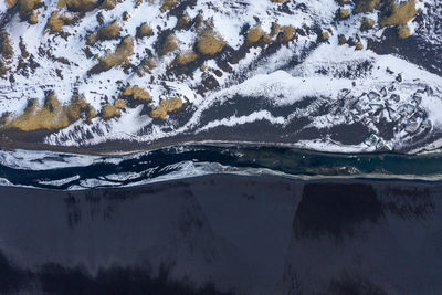 Scenic view of lake by snowcapped mountains during winter