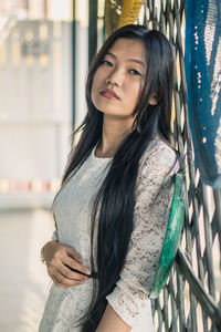 Beautiful young woman standing at home