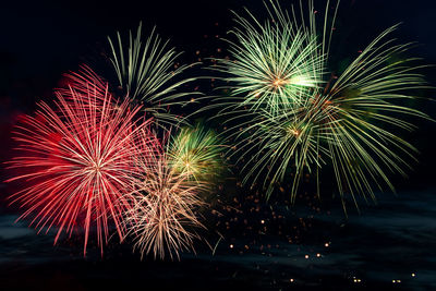 Low angle view of firework display at night