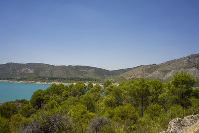 Scenic view of mountains against clear blue sky