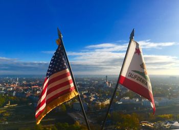 Low angle view of flag against blue sky