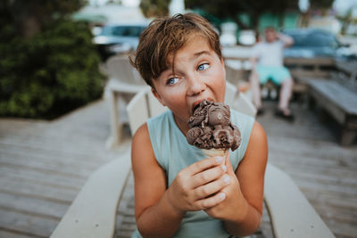 Portrait of smiling woman holding ice cream cone
