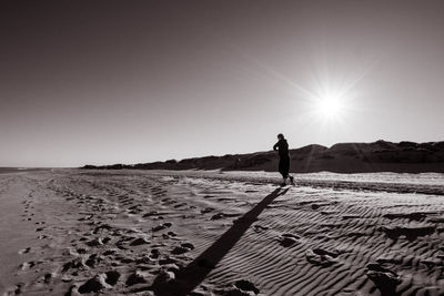 Woman walking on sand at beach