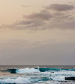 View of calm sea against cloudy sky