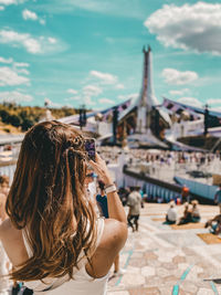 Side view of woman using mobile phone