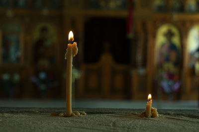 Close-up of illuminated candles in temple