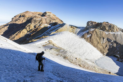 Rear view of man walking on mountain