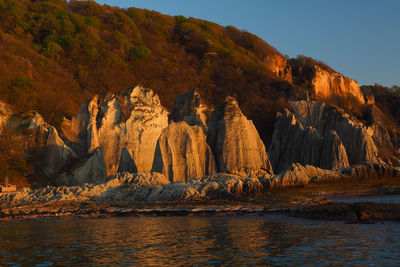 Rock formations by sea against sky.japan