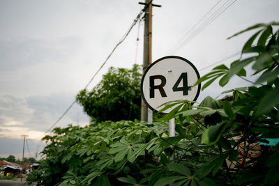 Low angle view of information sign against sky