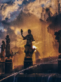 Statue of fountain against sky during sunset