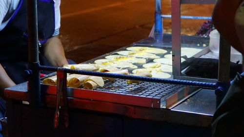 Man working on barbecue grill